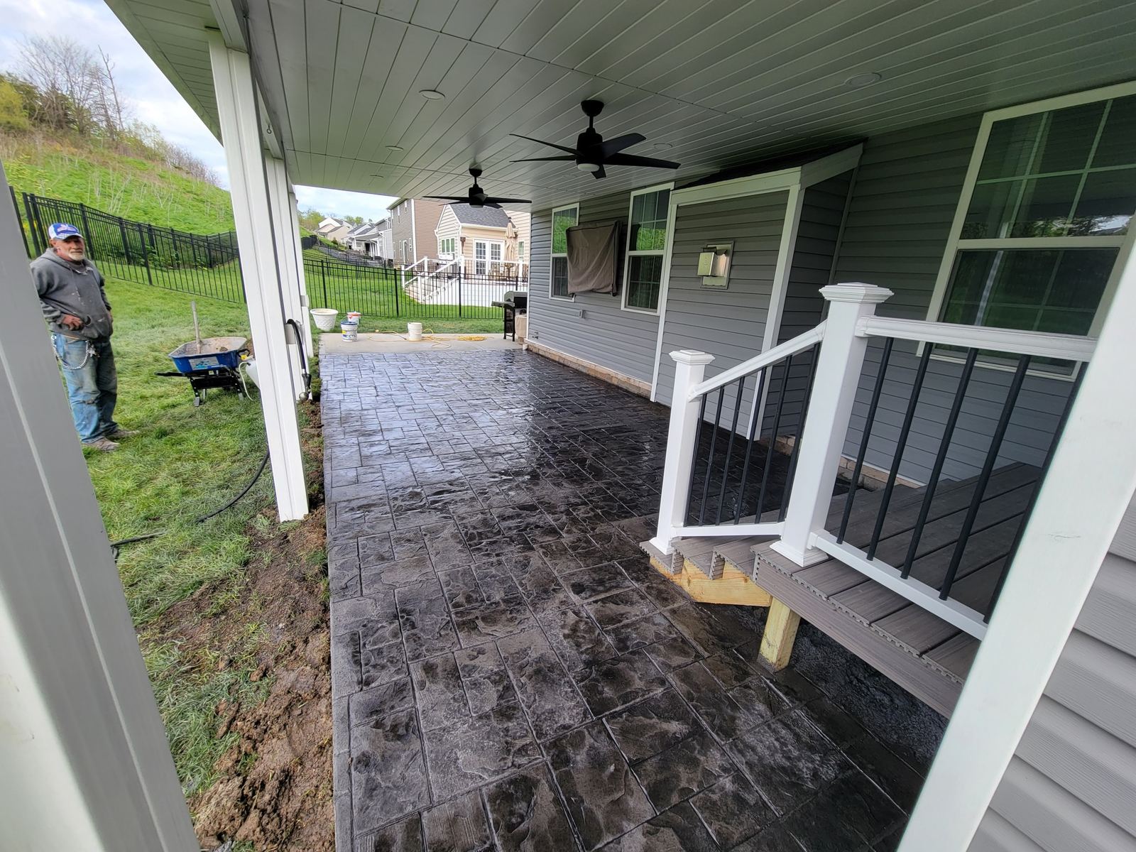 New stamped concrete patio under a covered back porch